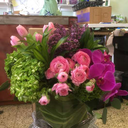 Pink and purple floral arrangement in a glass vase
