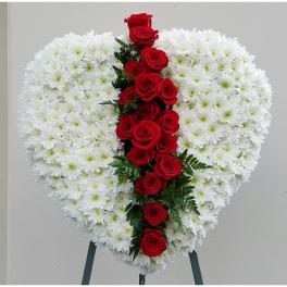 Heart-shaped white chrysanthemum wreath with a vertical line of red roses