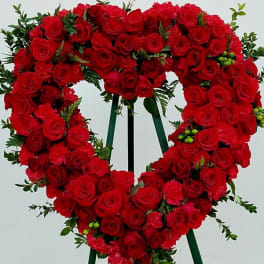 Heart-shaped red rose wreath on a standing easel