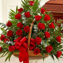 Basket of red roses with a red ribbon bow