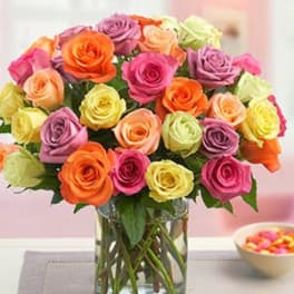 Bouquet of multicolored roses in a clear glass vase