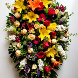 Large standing spray of mixed colorful flowers on an easel