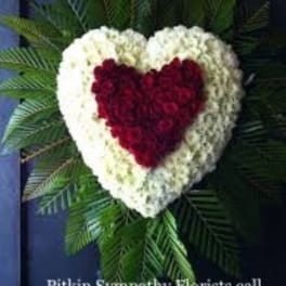 Heart-shaped floral wreath with red center and white border