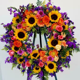 Large standing wreath of sunflowers, roses, and purple flowers