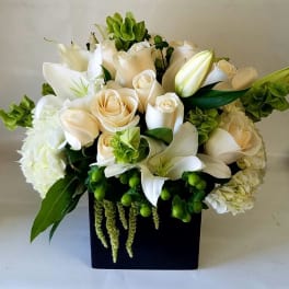 White and cream bouquet in a black square vase