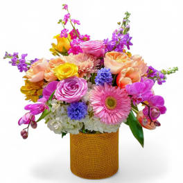 Colorful mixed bouquet in a textured gold cylinder vase
