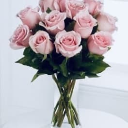 Bouquet of pale pink roses in a clear glass vase