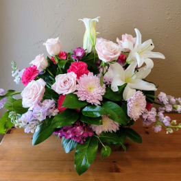 Bouquet of pink roses, lilies, and chrysanthemums with lavender accents
