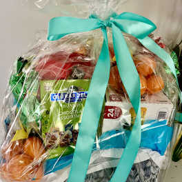 Gift basket with chocolates and colorful wrapped items tied with a turquoise ribbon