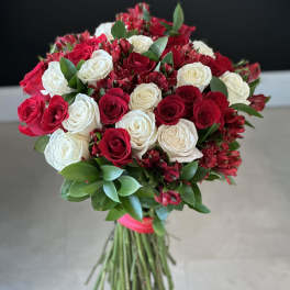 Bouquet of red and white roses with greenery