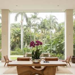 Purple orchids in a silver pot on a wooden table