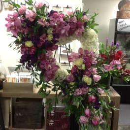 Large floral heart arrangement with pink, purple, and white flowers