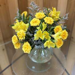 Yellow roses and alstroemeria in a clear glass vase