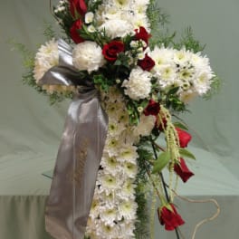 Standing floral spray with white chrysanthemums and red roses, accented by a silver ribbon