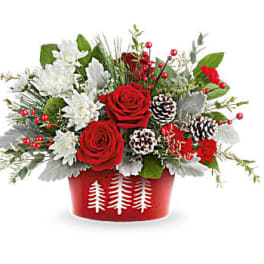 Red roses and white flowers in a red holiday container