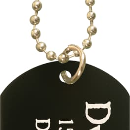 Black metal memorial tag on a beaded chain