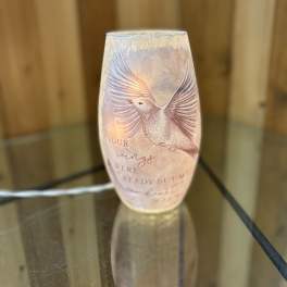 Decorative glass candle holder with a bird design and printed text
