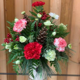 Mixed red, pink, and white flowers in a glass vase
