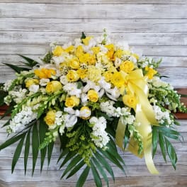Yellow and white floral spray with a yellow ribbon