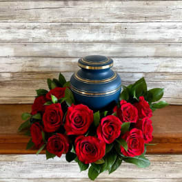 Red roses arranged around a blue urn