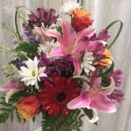 Mixed bouquet with pink lilies, red gerbera daisies, and orange roses