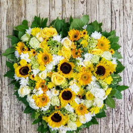 Heart-shaped bouquet of yellow sunflowers and white roses