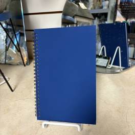 Blue spiral-bound notebook on a display stand
