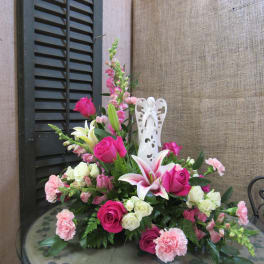 Pink and white floral arrangement with roses, lilies, and carnations