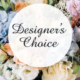 Pastel floral arrangement with a "Designer’s Choice" sign in the center