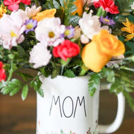 Mixed bouquet in a white mug labeled MOM