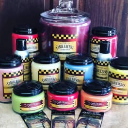 Assorted colorful candles and wax melts arranged in jars and packets
