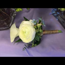 White calla lily and ranunculus boutonniere with blue accents