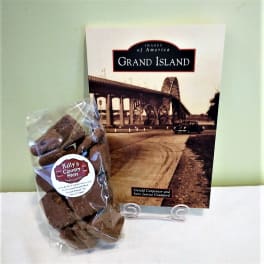 Bag of chocolates beside a Grand Island book