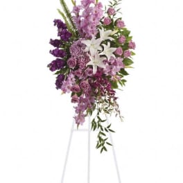 Tall purple and white floral standing spray on an easel