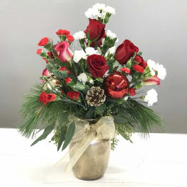Holiday bouquet of red roses and white carnations in a gold vase