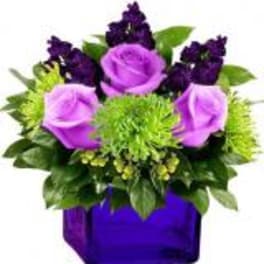 Purple roses and dark purple flowers in a purple vase