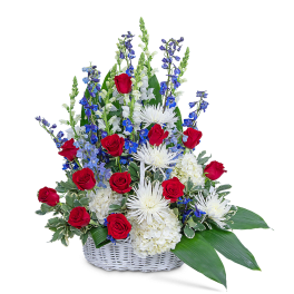 Basket arrangement of red roses, white blooms, and blue flowers