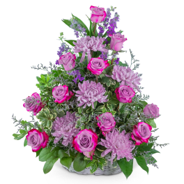 Pink roses and lavender chrysanthemums in a white basket