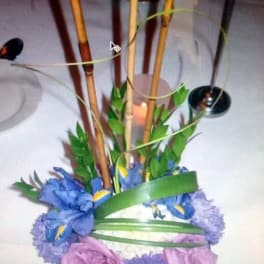 Blue and lavender floral arrangement with tall bamboo stems