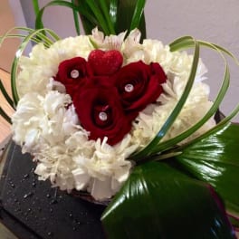 Red roses and white carnations arranged in a heart shape