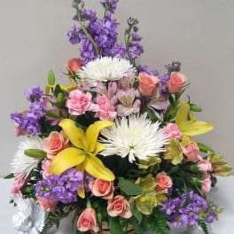 Mixed bouquet with yellow lilies, pink roses, white spider mums, and purple flowers
