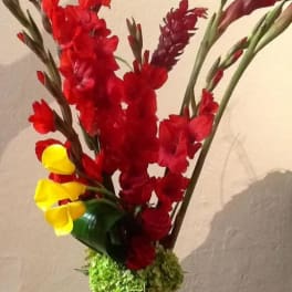 Tall bouquet of red and yellow gladiolus in a vase