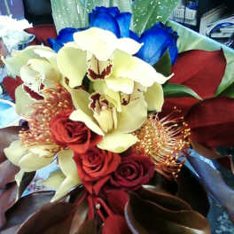 Bouquet of red roses and pale orchids with blue petals