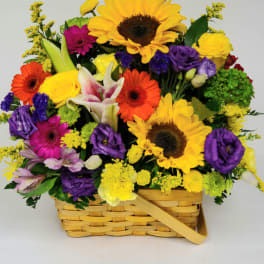 Colorful mixed flower basket with sunflowers, gerbera daisies, and roses
