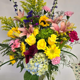 Mixed bouquet with yellow roses, lilies, hydrangea, and daisies