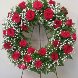 Red rose wreath with white baby's breath on a standing easel