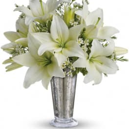 White lilies arranged in a silver vase