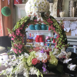 Large floral wreath with white and pink flowers on a table