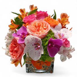 Mixed bouquet of roses and orchids in a glass vase