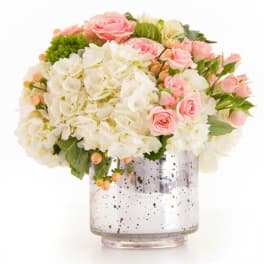 Pink and white bouquet in a speckled glass vase